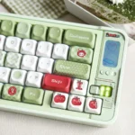 Close-up of vibrant green and red Apple PBT Keycaps Set. Durable dye-sub PBT material creates a fresh, playful keyboard look.