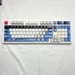 Exclusive Strike Freedom Gundam PBT keycap set display, showcasing sleek, high-contrast mecha silhouettes for a premium gaming setup.