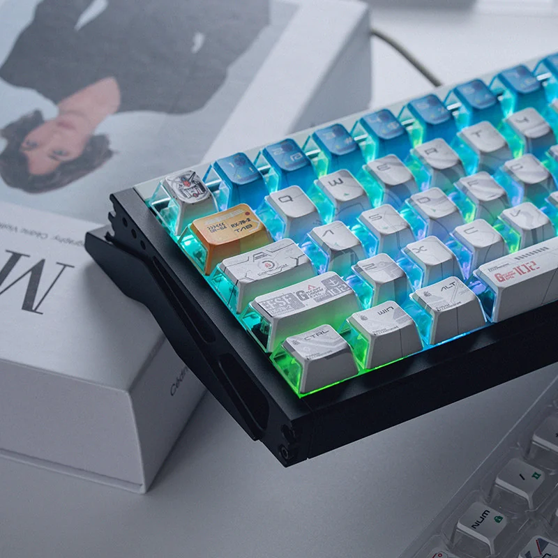 Iconic RX-78-2 Gundam PBT shine-through keycaps set displayed, highlighting their premium vibrant color scheme and detailed mecha-inspired legends.