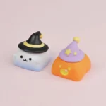Charming handcrafted resin Halloween artisan keycaps, depicting detailed ghost and pumpkin figures from various angles, highlighting artistic craftsmanship.