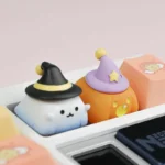Artistic handcrafted resin Halloween artisan keycap, a charming sculpted ghost and pumpkin design enhancing any mechanical keyboard.