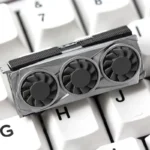 Close-up view of a unique handcrafted resin graphics card keycap, highlighting its detailed miniature replica design and vibrant artistic finish.