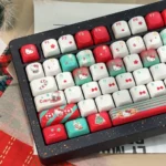 Iconic Hello Kitty Christmas PBT keycaps set in festive hues, with adorable character illustrations, shown from a playful angle.