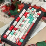 Playful, detailed shot of the iconic Hello Kitty Christmas PBT keycap set, showcasing its charming festive red and green character designs from a unique design.