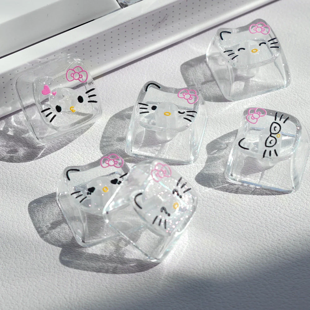 Playful Hello Kitty glitter backlit PC keycaps set, showcasing the transparent design with sparkling hearts and adorable cartoons.