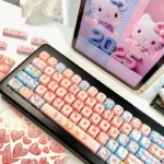 Close-up of the iconic Hello Kitty PBT Dye-Sub 130-keycap set. Vivid pink and white keys with charming Hello Kitty designs for a playful keyboard aesthetics.