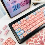 Detailed shot of the iconic Hello Kitty MOA PBT Dye-Sub Keycaps Set, highlighting the playful pink and white design and crisp dye-sub legends from a side view.