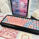 Playful Hello Kitty MOA PBT dye-sub keycaps set, showing the full 130-key set from various angles. Vibrant pink and white iconic designs bring charm.