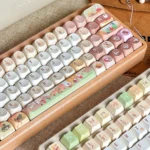 Collectible Q-version Hollow Knight Silksong Hornet keycap set. This artisan piece features vibrant game colors and intricate details, displayed from a unique design.
