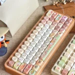 A charming Q-version Hollow Knight Silksong Hornet collectible keycap set, showcasing vibrant game-inspired colors and intricate artisan details from multiple angle.