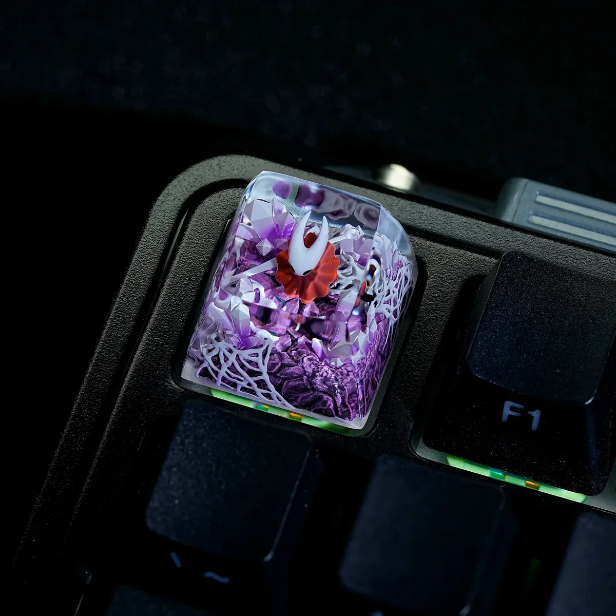 Close-up of the hand-painted translucent Hornet Hollow Knight ESC keycap, highlighting the intricate glowing details and dark fantasy artistry.