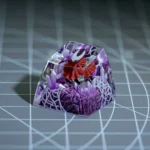 Hand-painted translucent Hornet Hollow Knight ESC keycap, intricately glowing with dark fantasy details from a distinct angle.