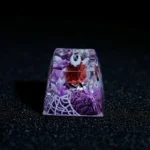 Artistic view of the hand-painted, translucent Hornet Hollow Knight ESC keycap, emphasizing its intricate glowing design and dark fantasy aesthetic design.