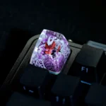 A detailed, artistic view of the hand-painted translucent Hornet Hollow Knight ESC keycap, showcasing its intricate glowing design and dark fantasy art.