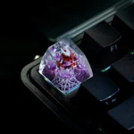 Close-up of an intricately hand-painted translucent Hornet Hollow Knight ESC keycap, glowing with dark fantasy artistry.
