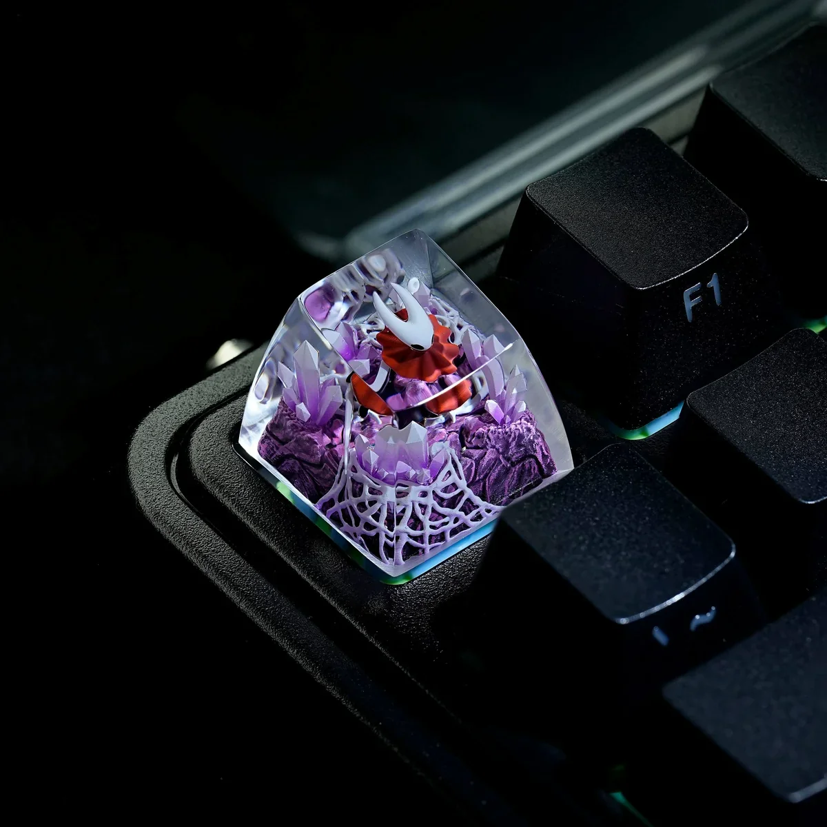 Close-up of an intricately hand-painted translucent Hornet Hollow Knight ESC keycap, glowing with dark fantasy artistry.