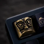Unique pure copper Sanxingdui Mask Keycap, with multi-angle views. It showcases ancient bronze mystique blended with whimsical pop culture.