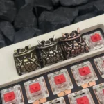 A close-up view of the handcrafted Japanese Oni Keycap, showcasing its striking samurai mask design and detailed vintage finish from a unique angle.