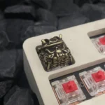 Close-up views of a handcrafted Japanese Oni Samurai artisan keycap, highlighting its striking detailed design and vibrant vintage finishes.
