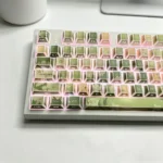 Jasmine Snow Bud PBT Keycaps Set with translucent side-engraved legends and delicate jasmine floral design, emphasizing artistic light reflections.