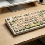 Jasmine Snow Bud PBT Keycaps Set, displaying translucent side-engraved legends from a unique angle. Delicate jasmine florals with subtle light reflection.
