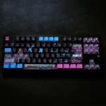 Detailed shot of exclusive Jinx Arcane PBT + PC keycaps set, displaying their vibrant, chaotic, punk-inspired League of Legends aesthetic from a unique angle.