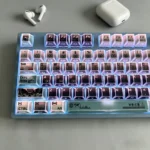 Exclusive Kaiju No. 8 faceted side-lit PBT keycaps set displayed from various angles, highlighting their dark, angular design and translucent facets.