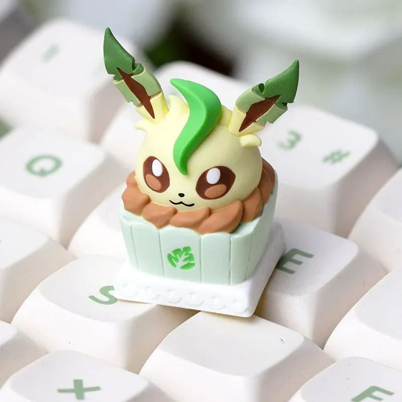Close-up of a unique Leafeon artisan keycap, sculpted as a whimsical cake. This adorable Pokemon collectible enhances any keyboard.