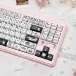Playful line art cat PBT keycaps set in MAO profile, showcasing their whimsical minimalist design and durable texture from a charming side view.