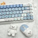 A close-up view of several Playful Little Bear PBT MOA ergonomic keycaps set, showcasing their adorable white bear illustrations and gentle charm from various angle.