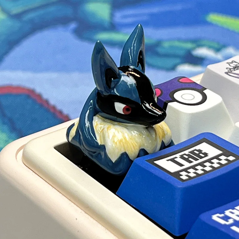 A vibrant, handcrafted Lucario artisan keycap made from detailed resin, showcasing the iconic Pokemon character on an ESC key for keyboard customization.