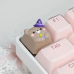 Close-up of a handcrafted Magic Bear artisan ESC keycap, showcasing its whimsical forest creature design and intricate details. A playful desktop accent.