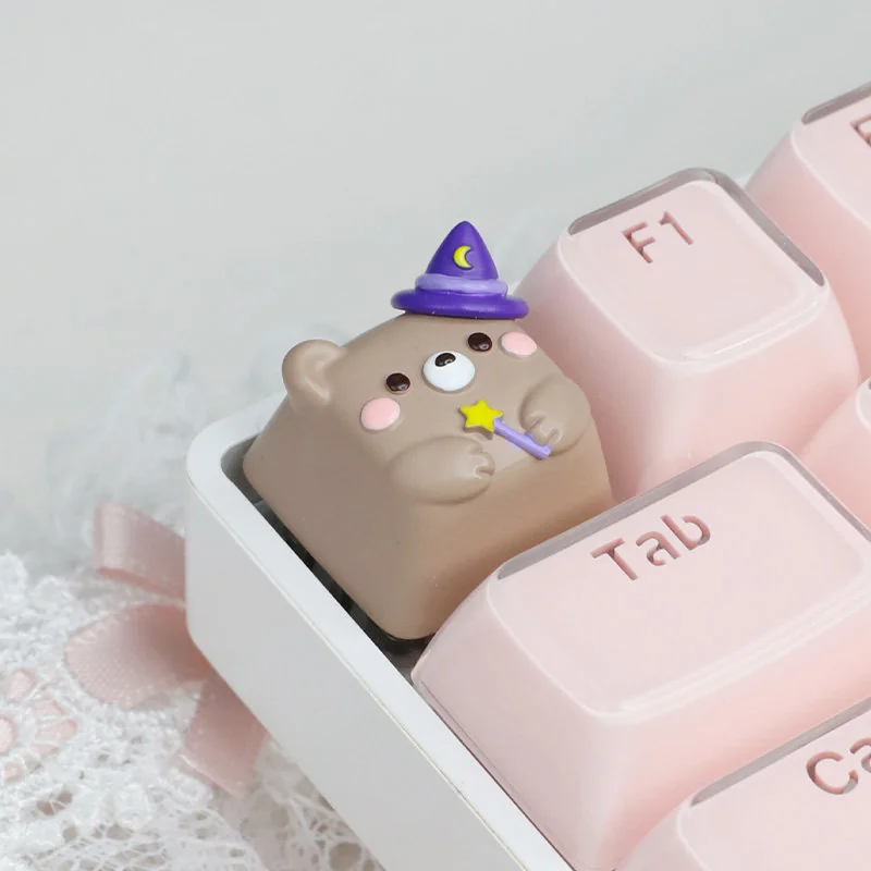 Close-up of a handcrafted Magic Bear artisan ESC keycap, showcasing its whimsical forest creature design and intricate details. A playful desktop accent.