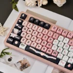 Close-up views of the adorable black and pink maid cat keycap set from various angles, highlighting its charming and playful aesthetic for mechanical keyboard.