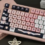 Multiple angles of the adorable black and pink maid cat keycap set, showcasing its charming and playful design perfect for keyboard customization.