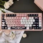 Adorable black and pink maid cat keycap set showcasing its charming, playful design and unique aesthetic as a delightful keyboard accent.