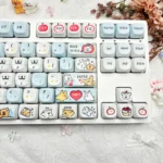 Charming Maltese keycap set featuring adorable PBT MOA dog designs and playful apple details, displayed from various perspectives.