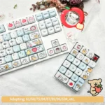 Detailed close-up of an adorable Maltese PBT MOA keycap set, showcasing its charming dog illustration and playful apple accent for a cute keyboard aesthetics.