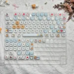 Adorable Maltese PBT MOA keycap set, showcasing charming dog and apple illustrations from a unique angle for a playful keyboard.