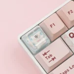 Angled shot of the handcrafted resin Maltese dog ESC keycap, highlighting the whimsical line-art Maltese puppy in a clear resin casing.