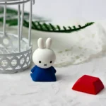 Close-up of an adorable Miffy & Friends resin keycap (ESC key) from a charming angle, showcasing the whimsical handcrafted details and vibrant colors.