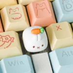 A whimsical handcrafted Miffy Carrot resin keycap for the Esc key, showcasing its detailed sculpting and playful design from multiple angles on a desk.