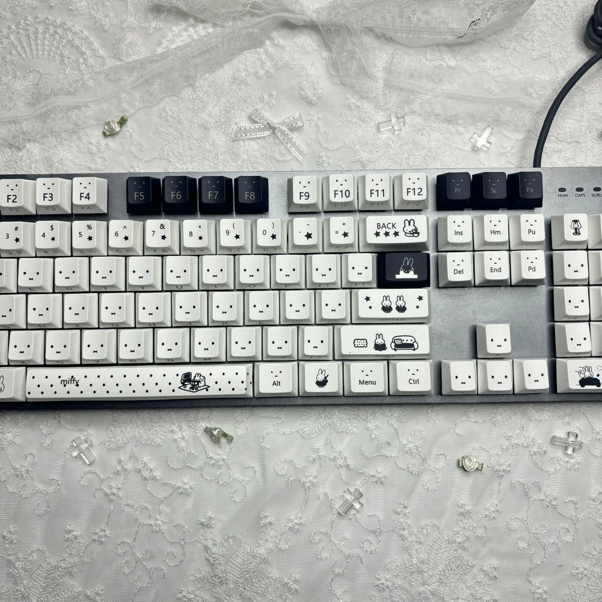 Miffy PBT backlit keycaps set from a playful angle, showcasing iconic Miffy characters, durable PBT, and clean design for joyful typing.
