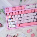 A gallery of Mika Misono keycaps set from various angles, highlighting the exclusive Blue Archive art set with vibrant character legends and premium detail angle.