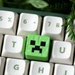 Handcrafted Minecraft Artisan ESC keycap, showcasing its vibrant pixelated resin art from a distinct angle. Features iconic Minecraft design, a unique design.