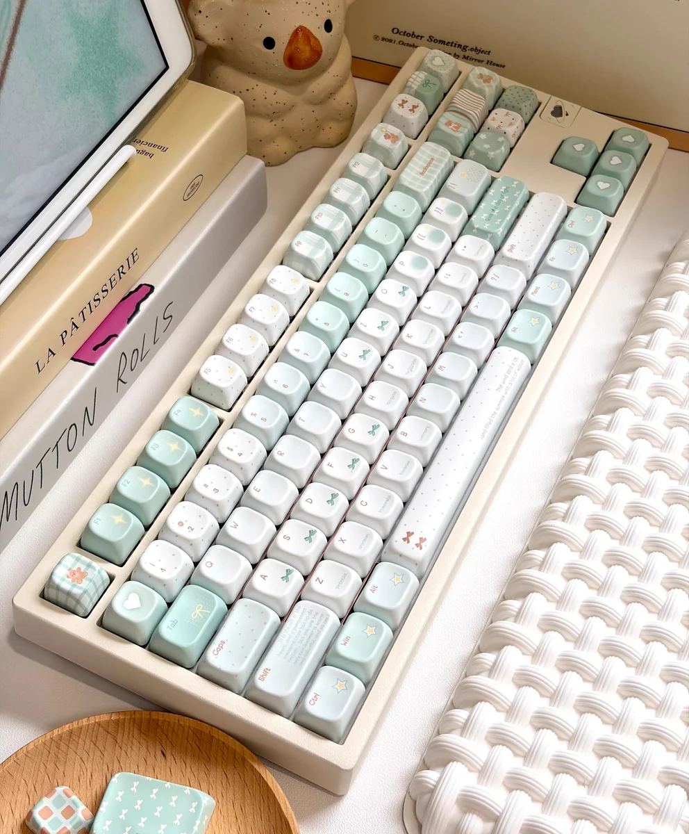 Artistic close-up of serene misty mint PBT+PC translucent keycaps set, showcasing their refreshing ethereal glow from an alternate perspective.