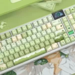 An angled view of the Serene Mountain Stream Side-Lit PBT Keycap Set, highlighting its luminous side-engraved legends and tranquil stream design.