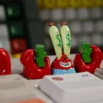 Multiple angles of the vibrant Mr. Krabs keycap, an intricate SpongeBob resin artisan for mechanical keyboards, highlighting character accuracy.