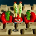 Multi-angle views of the iconic Mr. Krabs resin artisan keycap for keyboards, with vibrant, intricate SpongeBob money details.