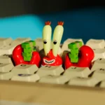 Iconic Mr. Krabs resin artisan keycap featuring normal eyes and intricately detailed money-clasping claws, a vibrant SpongeBob addition for keyboards.